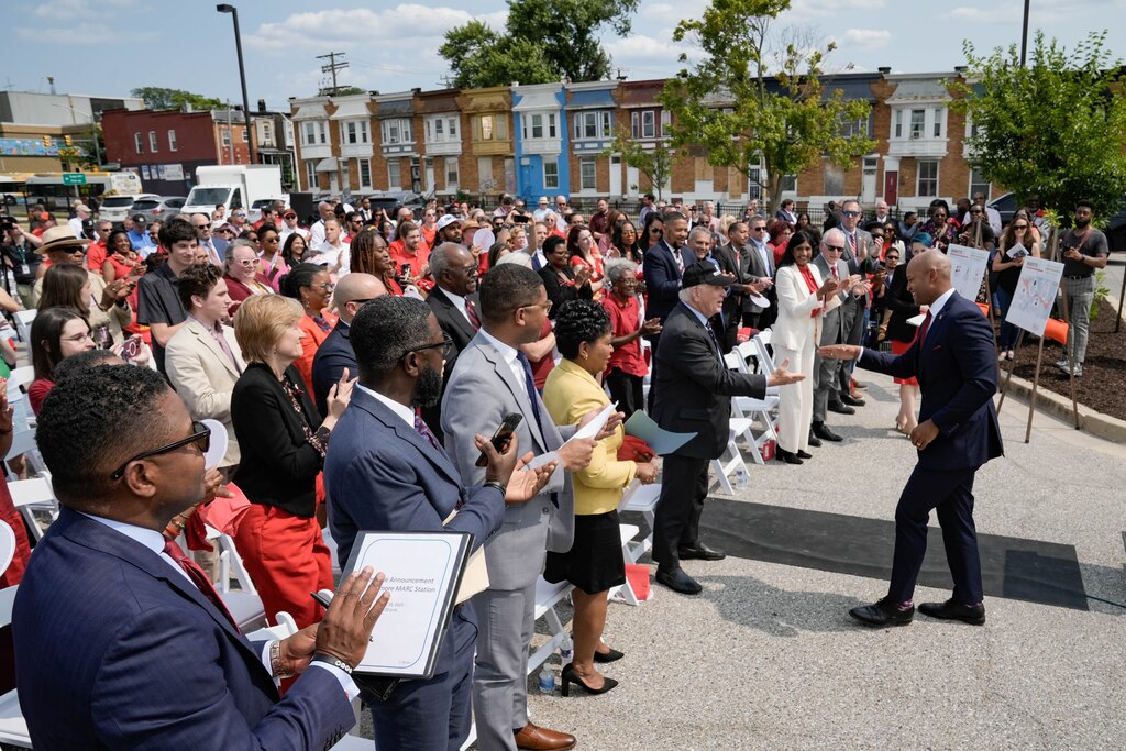 Governor Wes Moore walks back into a standing ovation at a press conference to announce the continuation of the Red Line proposal on Thursday, June 15, 2023.