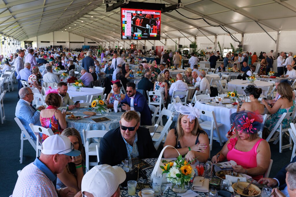 Attendees sit in the infield during The Preakness Stakes at Pimlico Race Course on Saturday, May 17, 2025, in Baltimore.