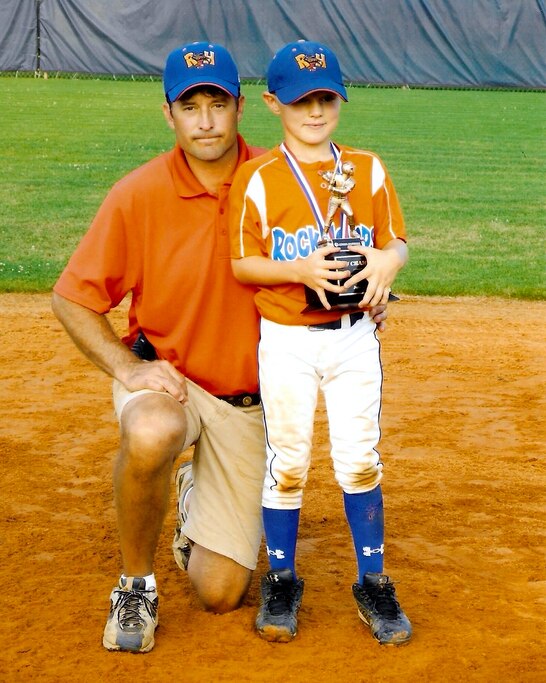 A 7-year-old Gunnar Henderson poses with his dad, Allen.