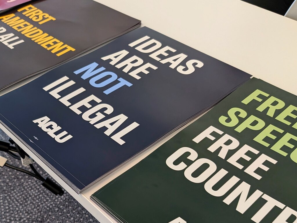 The ACLU handed out posters, button and stickers promoting the protection of free speech at a town hall meeting on June 8, 2025 in Wheaton.