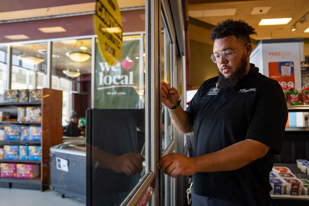 Corey Thomas demonstrates how to lock the glass entrance doors.