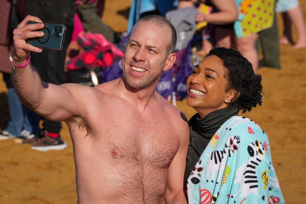 Two people take a selfie together after exiting the freezing water at the Polar Bear Plunge on 2/4/23 at Sandy Point State Park. The event, now in its 27th year, has raised more than $3.4 million for Special Olympics Maryland this year.