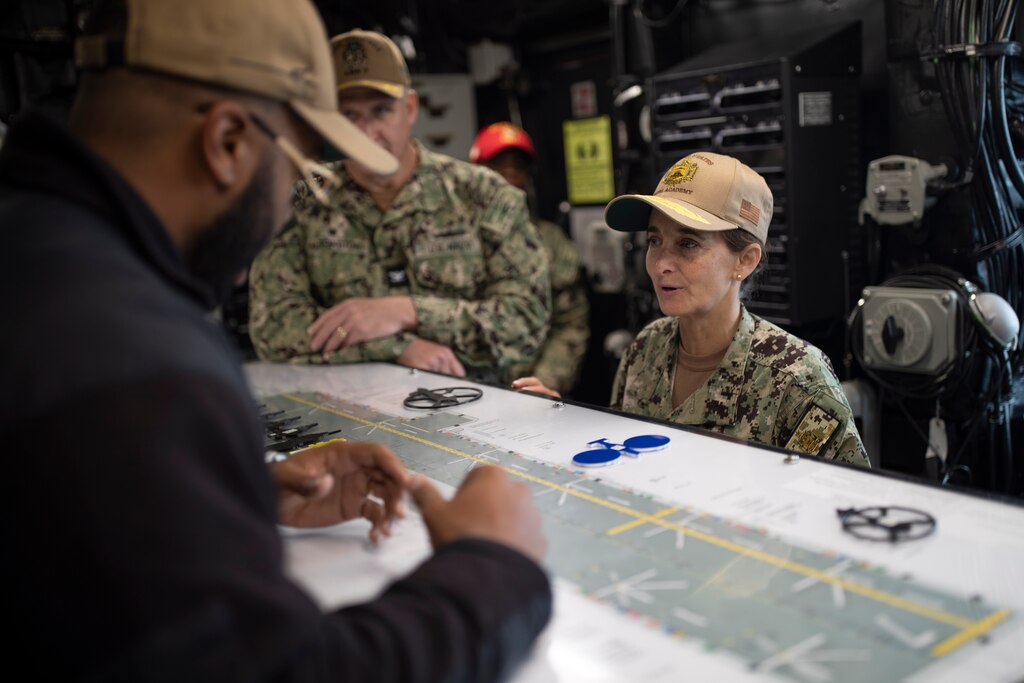 Aviation Boatswain’s Mate 2nd Class Khalil Johnson, from Cleveland, speaks with Vice Adm. Yvette Davids, superintendent of the U.S. Naval Academy, about the ship’s flight deck during a tour of amphibious assault carrier USS Tripoli (LHA 7), June 12, 2024. Tripoli is an America-class amphibious assault ship homeported in San Diego.