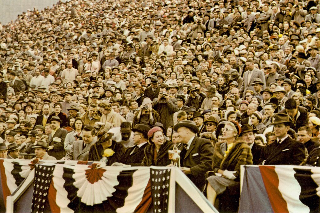 A color photograph from the Terrapin yearbook of Queen Elizabeth sitting in the stands watching a Maryland football game, 1957. Courtesy of University of Maryland Archives.
