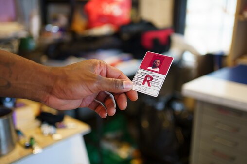 Waymond Harrison shows his former corrections facility card on June 17, 2025. The “R” stands for release.