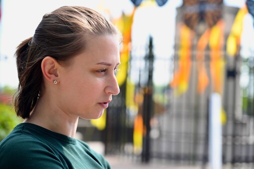 Hannah Pursley is a clinical social worker who was laid off from her job that provided legal and social services to immigrants in March when their contract with the government ended. She prepares to speak during the March for Migrant Justice at Columbus Park in Baltimore on Thursday, May 1, 2025.