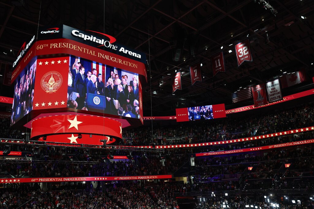 WASHINGTON, DC - JANUARY 20: People watch the inauguration of U.S. President-elect Donald Trump from the Capital One Arena on January 20, 2025 in Washington, DC. Donald Trump takes office for his second term as the 47th president of the United States.