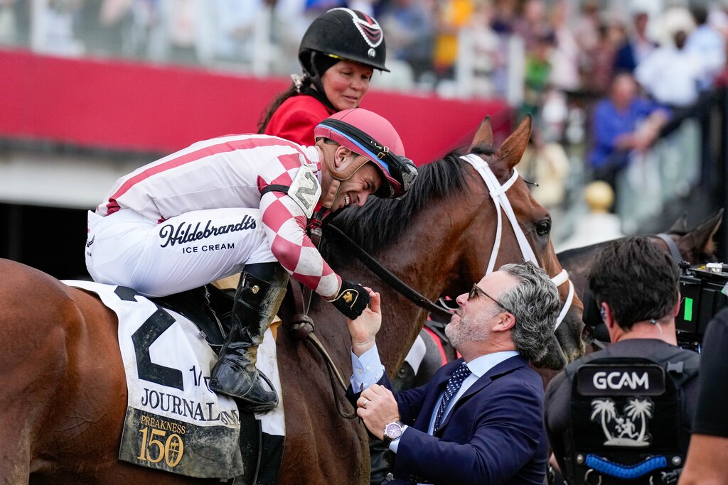 Umberto Rispoli, riding Journalism, celebrates with one of the horse’s owners, Aron Wellman, after winning the 150th running of the Preakness Stakes at Pimlico Race Course in Baltimore, Md. on Saturday, May 17, 2025.