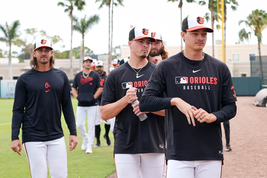 Baltimore Orioles pitcher Cade Povich, right, walks to the dugout with his fellow pitchers ahead of a Grapefruit League game against the Pittsburgh Pirates at Ed Smith Stadium in Sarasota, Fla. on Saturday, February 22, 2025.
