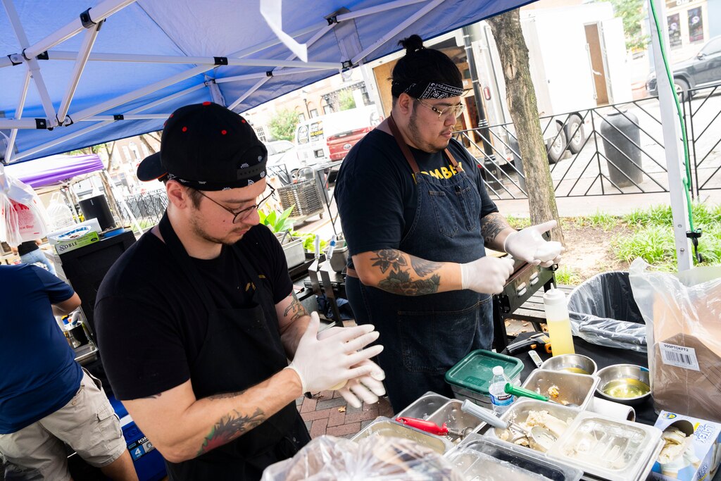 Marvin Rodriguez prepares pupusas at the Fells Point Farmer's Market on June 29, 2025. His new restaurant, Aru Aru, is set to open this Fall adjacent to Fells Point.