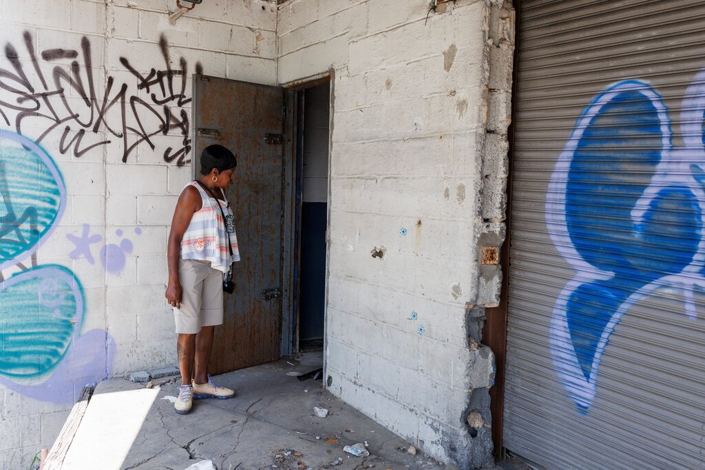 Cassandra Williams, a Certified Peer Recovery Specialist with Penn North Recovery checks on people using inside an abandoned building on Friday, July 11, 2025 in Baltimore. Just a day following a mass-overdose in the area.