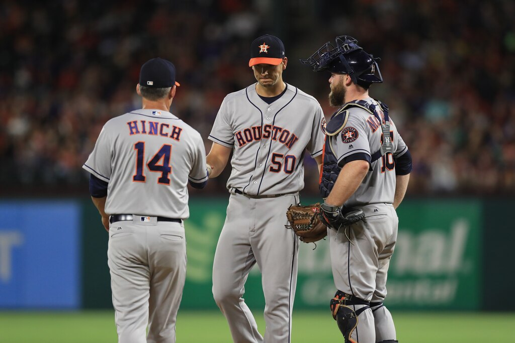 ARLINGTON, TX - AUGUST 11: Charlie Morton #50 of the Houston Astros talks with Brian McCann #16 while A.J. Hinch walks to the mound against the Texas Rangers in the third inning at Globe Life Park in Arlington on August 11, 2017 in Arlington, Texas.