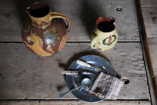 A traditional table setting with utensils, plates and jugs on the dining room table inside of Fort Garrison in Pikesville, Md. on Monday, June 16, 2025.