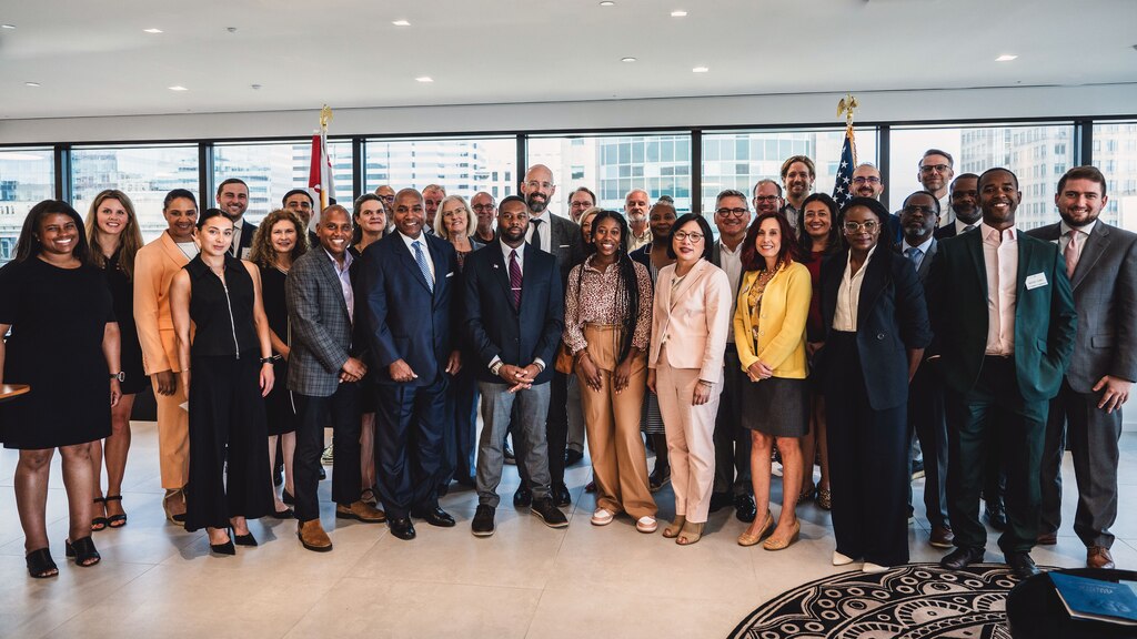 A group photograph of key partners taken at the GBC Office. Notable individuals are GBC President and CEO Mark Anthony Thomas, GBC Board Chair and UMMS President and CEO Dr. Mohan Suntha, EDA Tech Hubs Program Director Eric Smith.