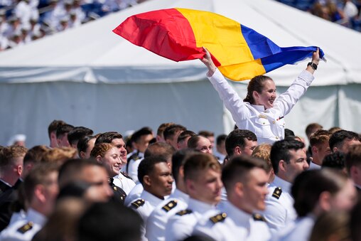 Ioana Cezara Vlad, an international student from Romania, waves her country’s flag during the U.S. Naval Academy’s graduation ceremony at the Navy-Marine Corps Memorial Stadium on May 26, 2023. The graduating midshipmen are commissioned as either an ensign in the U.S. Navy or a 2nd Lieutenant in the U.S. Marine Corps.