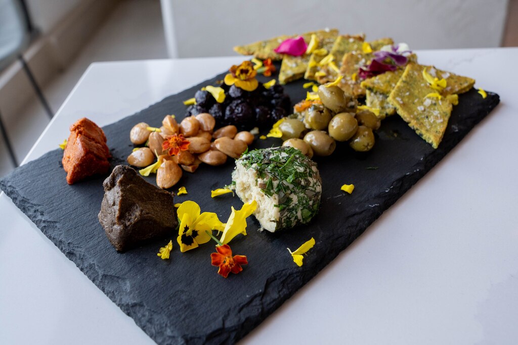 Artisanal Cheese Plate featuring pickles, jam and seedy crackers at Liora.