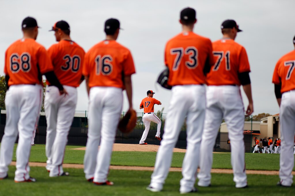 Baltimore Orioles pitcher Brian Matusz (17) participates in a drill as other pitchers wait their turns during a baseball spring training workout in Sarasota, Fla., Wednesday, Feb. 25, 2015.