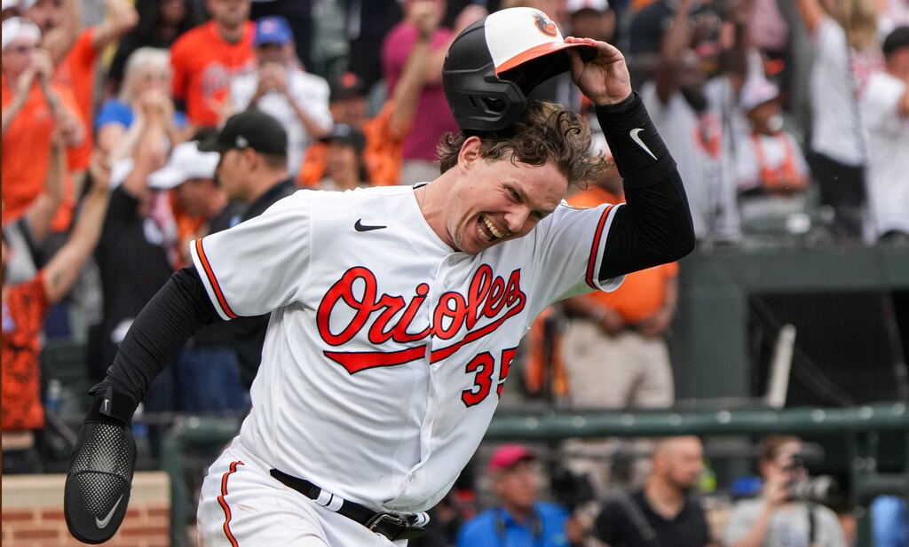 Baltimore Orioles catcher Adley Rutschman (35) cheers after scoring on center fielder Cedric Mullins’ sacrifice fly in the eleventh inning to win the game against the Tampa Bay Rays on Sunday, September 17, 2023. The Baltimore Orioles clinched a spot in the postseason for the first time since 2016.