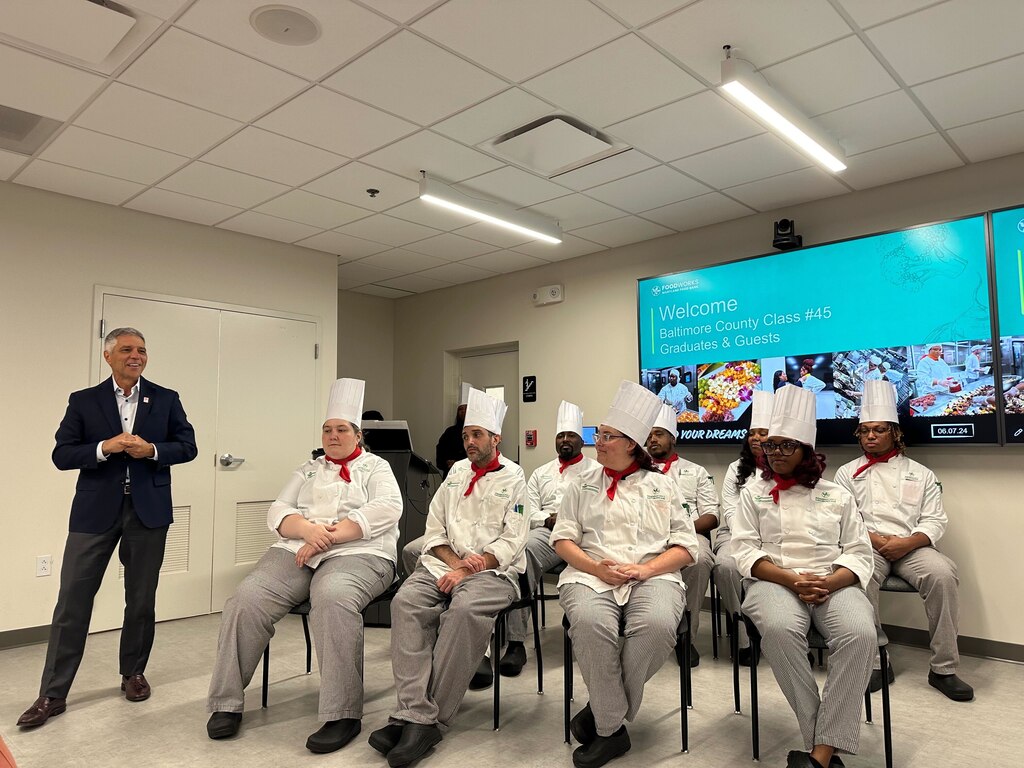 Carmen Del Guercio with FoodWorks graduates in December 2024.