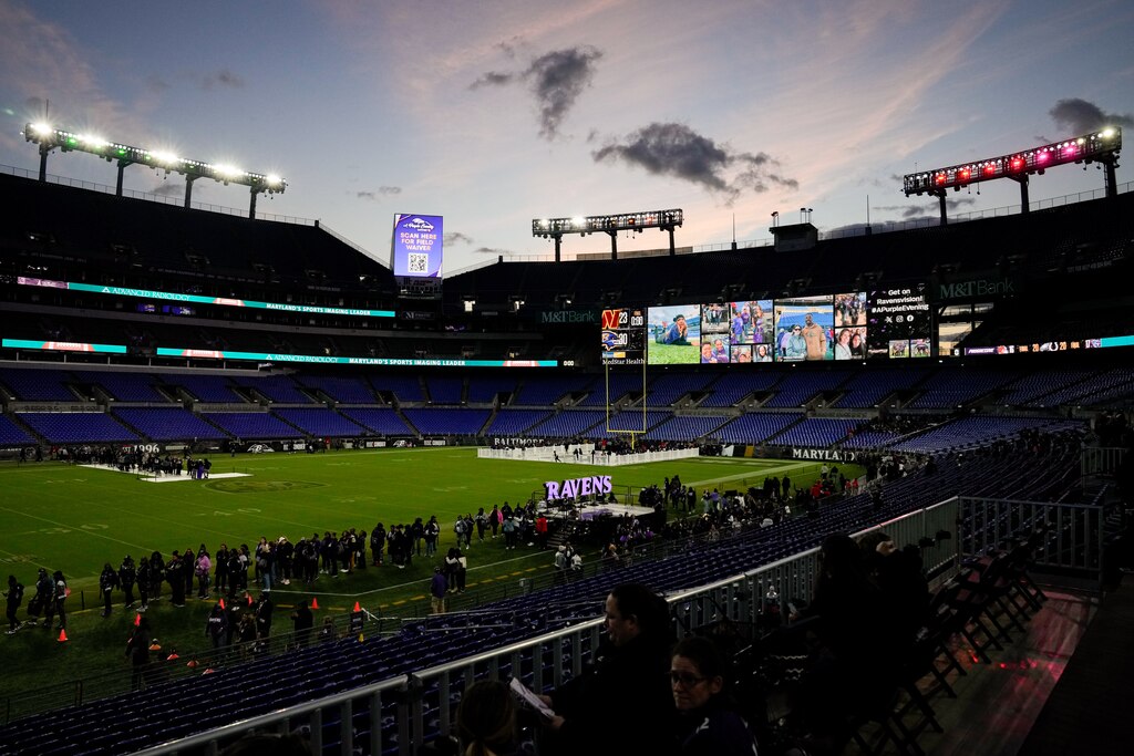 The sun sets as fans arrive for A Purple Evening, the Baltimore Ravens’s annual women’s event, at M&T Bank Stadium in Baltimore on Monday, October 14, 2024.