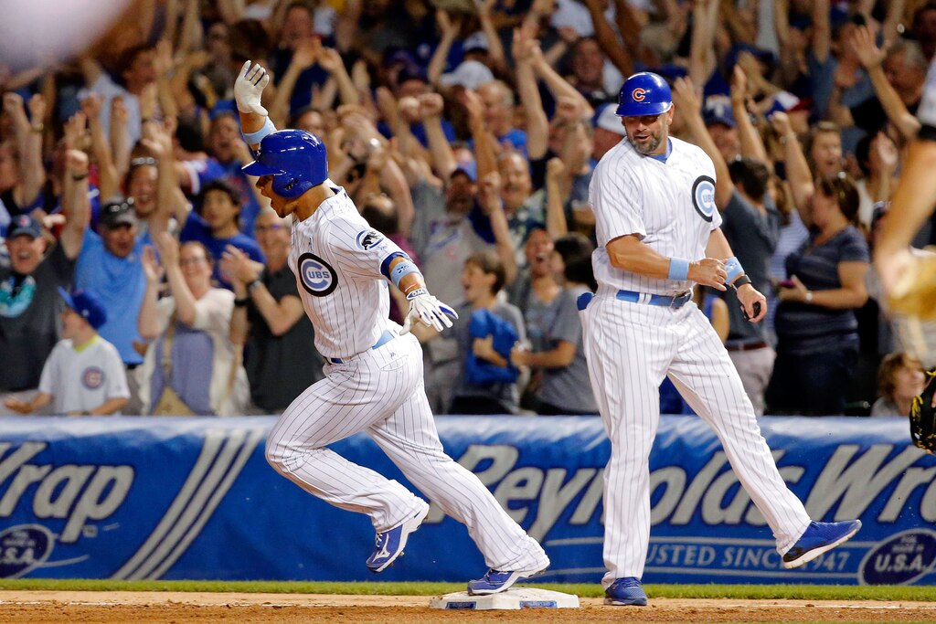 CHICAGO, IL - JUNE 19: Willson Contreras #40 of the Chicago Cubs celebrates with first base coach Brandon Hyde #16 (R) after hitting a two run home run on the first pitch of his MLB debut during the sixth inning against the Pittsburgh Pirates at Wrigley Field on June 19, 2016 in Chicago, Illinois. (Photo by Jon Durr/Getty Images)