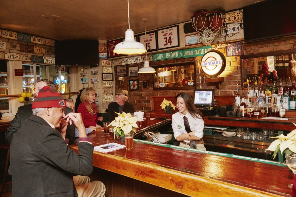 Brown could often be found sitting in the corner of the bar, especially during happy hour, drinking a glass of wine. His favorite seat was right below a street sign hung on the wall: John Brown Rd.