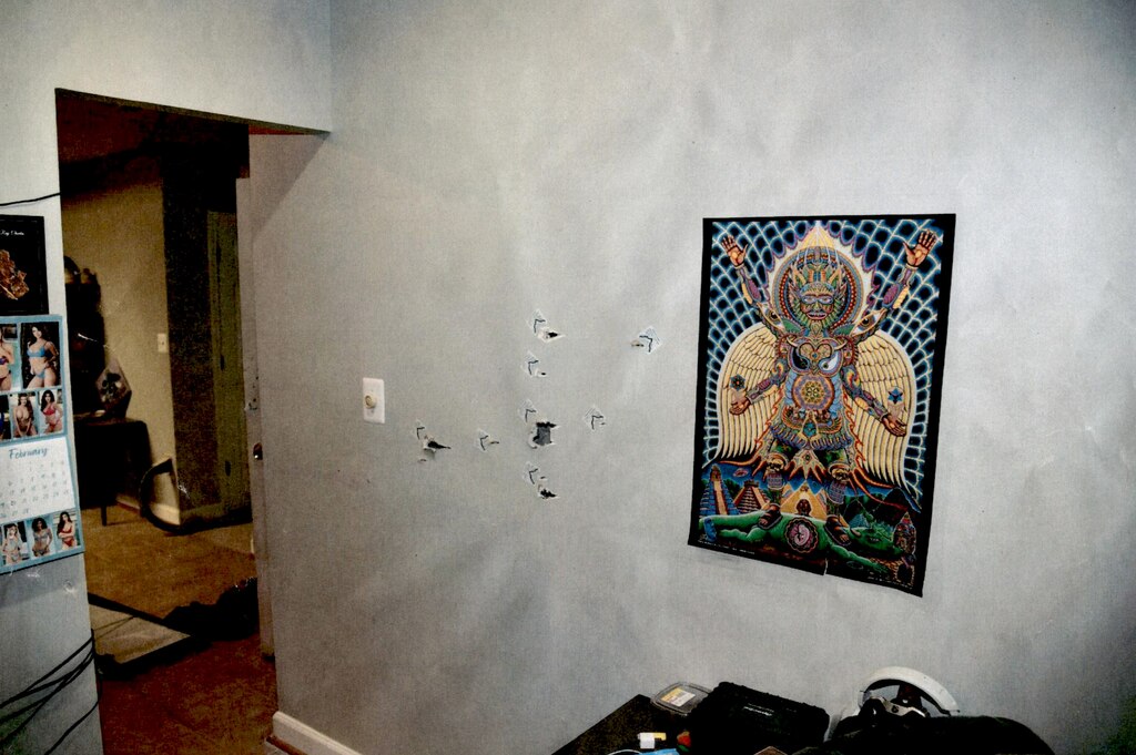 State's Exhibit 2a shows bullet holes in the walls of David Linthicum’s room after the first shooting.