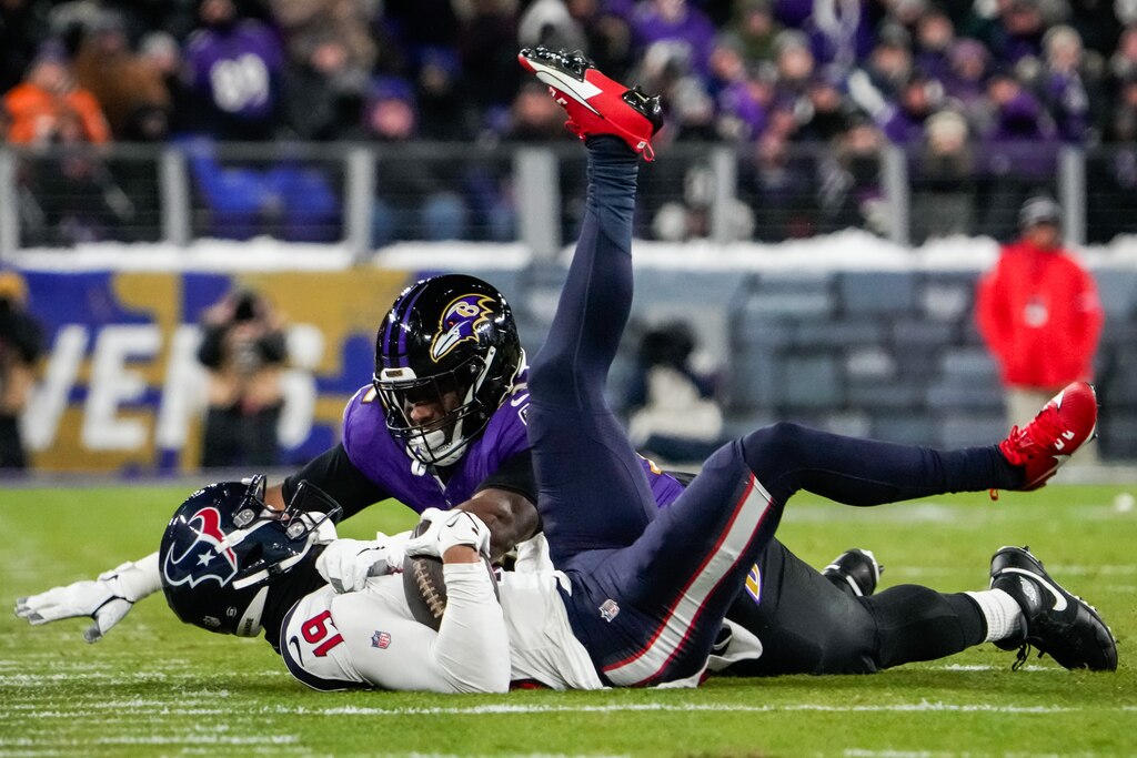 Baltimore Ravens defensive tackle Justin Madubuike (92) tackles Houston Texans wide receiver Xavier Hutchinson (19) during the second quarter of the AFC divisional playoff game at M&T Bank Stadium on Saturday, Jan. 20, 2024.