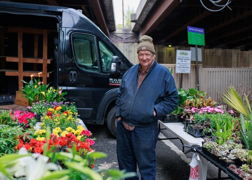 Joel McKeown, owner of Locust Point Greenhouse out of Elkton, MD poses for a photo at the Baltimore Farmer’s Market opening day in downtown Baltimore, MD on April 13, 2025.