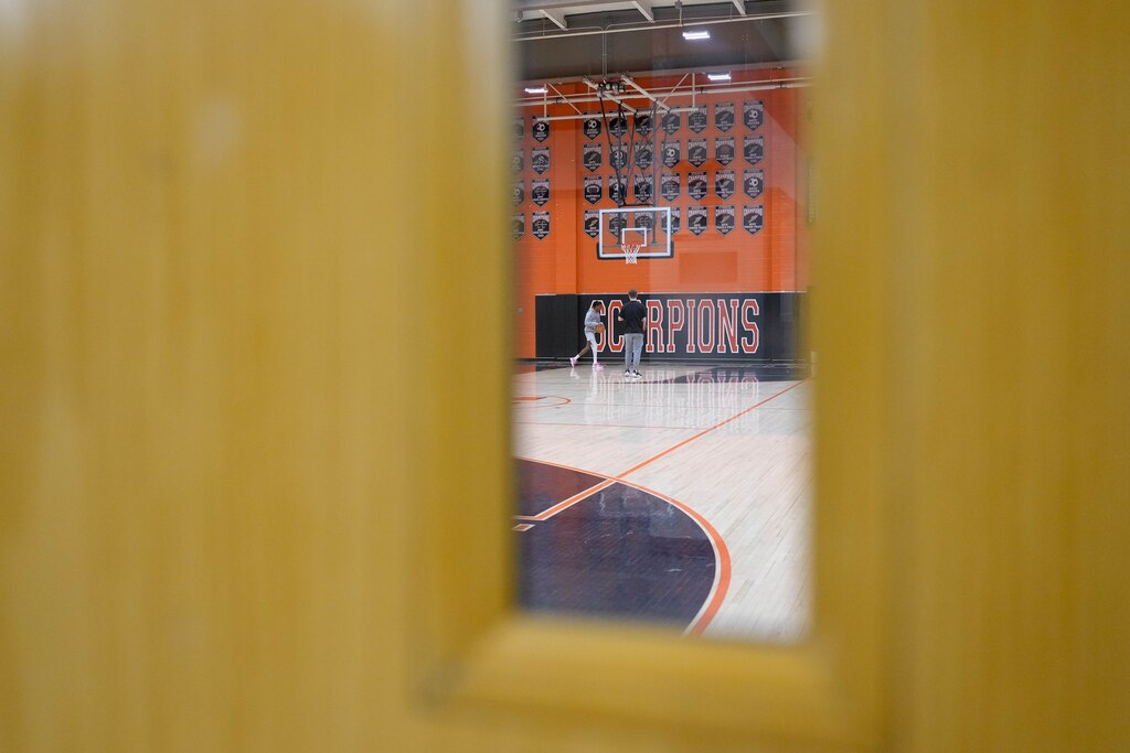 People play basketball inside the gymnasium at Oakland Mills High School in Columbia, Md. on Wednesday, April 9, 2025.