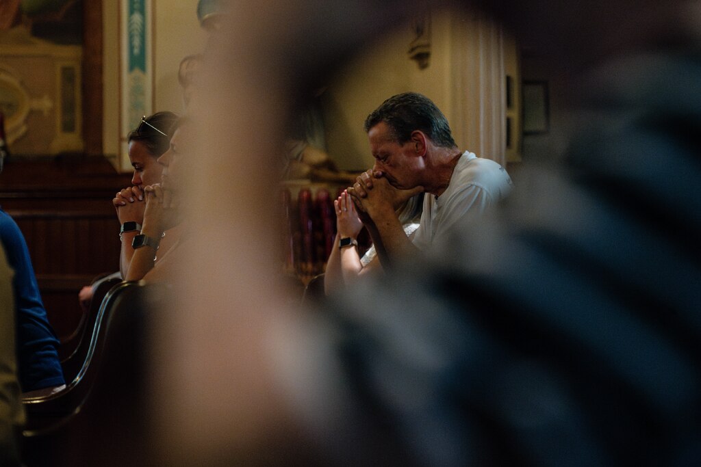 Parishioners of St. Leo the Great Roman Catholic Church pray during a mass held on June 22, 2025 in Baltimore, MD.
