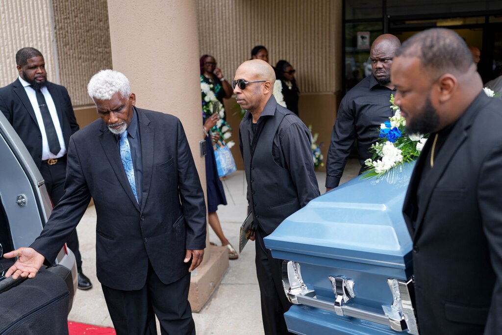 Dontae Melton, Sr., father of Dontae Melton Jr., center, helps carry the casket holding his son as its loaded into the hearse waiting outside of DreamLife Worship Center in Randallstown, Md. on Saturday, July 12, 2025. The 31-year-old died in police custody in June, just one day after his mother had attempted to file an emergency petition in court out of concern for his mental health.