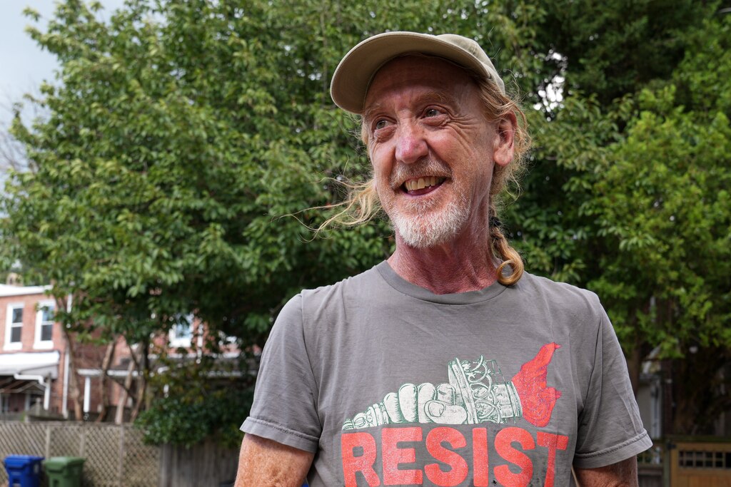 Artist Ashley Kidner talks about his plans to breathe new life into Mathilda Lorenz’s empty casket outside his garage on July 28, 2022. The mysterious casket was originally found down by a stream in Wyman Park.