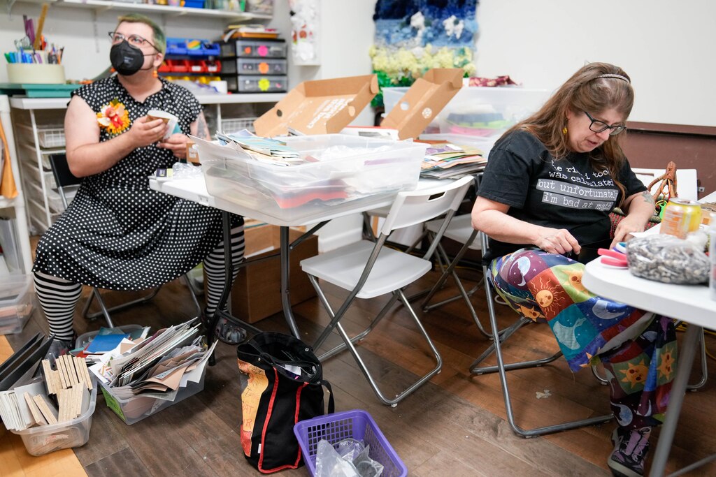 Volunteers Yates Godfrey, left, and Jill Kyle-Keith sort through stacks of donated materials at SCRAP Creative Reuse in the Pigtown neighborhood of Baltimore, Md. on Wednesday, May 7, 2025.