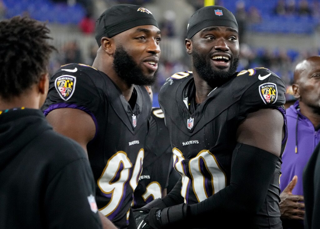 Baltimore Ravens linebackers Odafe Oweh (99) and David Ojabo (90) react after hearing about Kyle Van Noy’s sack achievement in a game against the Buffalo Bills at M&T Bank Stadium in Baltimore on Sunday, September 29, 2024.