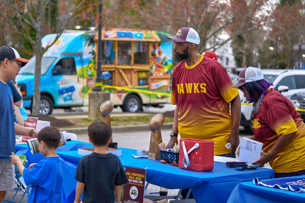 George Garrett, commissioner of PAL Football, talks about his program at the PlayAnnapolis sports fair in April at the Boys & Girls Club all-weather turf field.