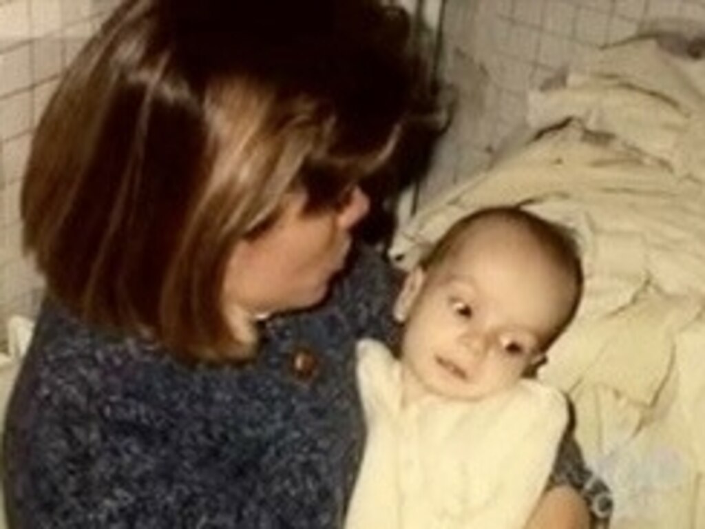 Sharon Dennehy in 1994 holding George Dennehy on the day they met in the Romanian orphanage. Photo courtesy of Mike Dennehy.