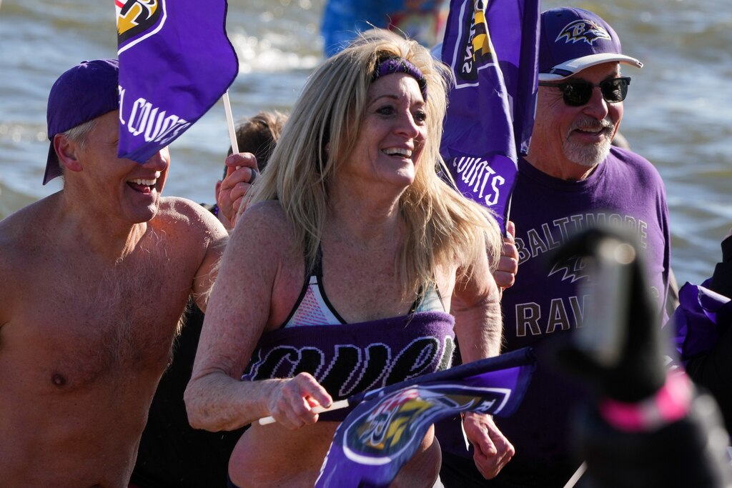 Plungers quickly exit the freezing water to dry off at the Polar Bear Plunge on 2/4/23 at Sandy Point State Park. The event, now in its 27th year, has raised more than $3.4 million for Special Olympics Maryland this year.