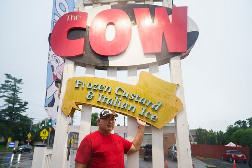 Owner Mike Reiner stands in front of his store’s recognizable sign at The Cow ice cream shop in Reistertown, Md. on July 1, 2025.