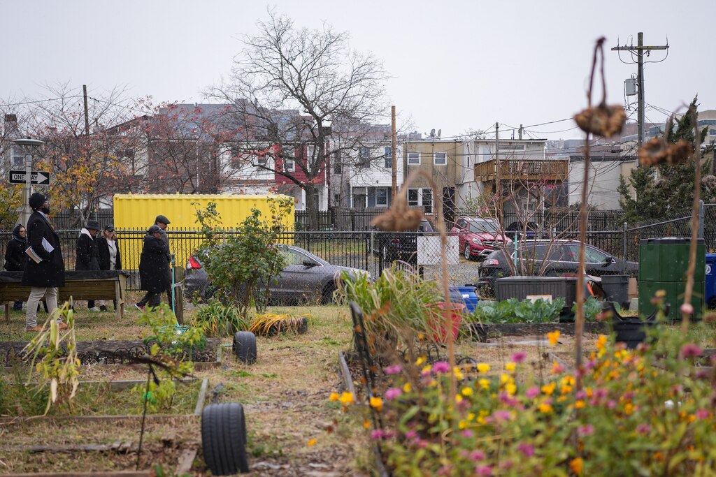 EPA Regional Administrator Adam Ortiz and a group of community members and government officials take a tour of Madeira Street Garden in the Middle East neighborhood of Baltimore, Md. on Friday, November 22, 2024.