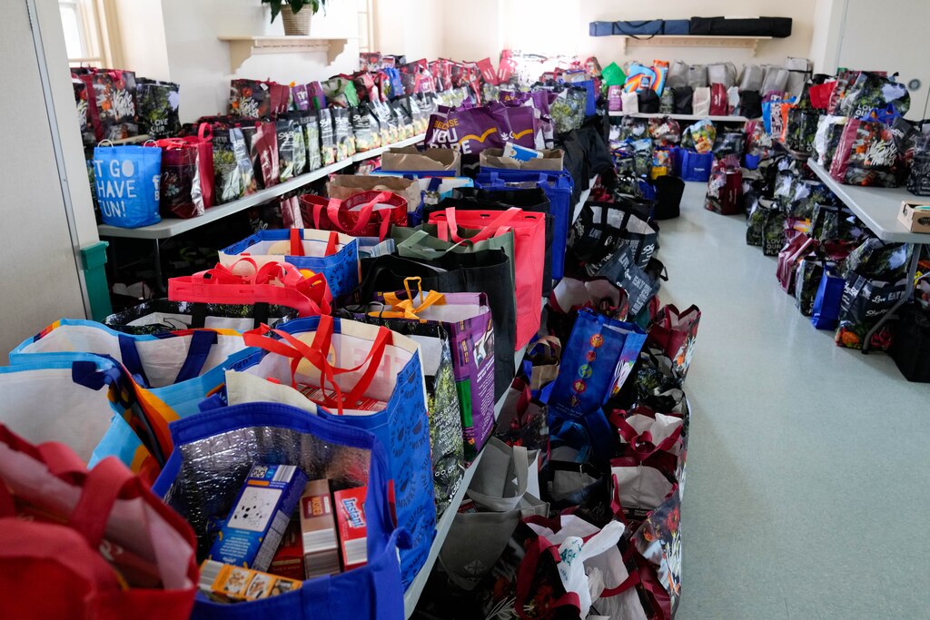 Bags of food ready to hand out to local residents sit inside the cafeteria during a Thanksgiving holiday meal giveaway at Trinity Episcopal Church in Towson, Md., on Monday, November 24, 2025. The Assistance Center of Towson Churches organized the event, which was also held in 2024.