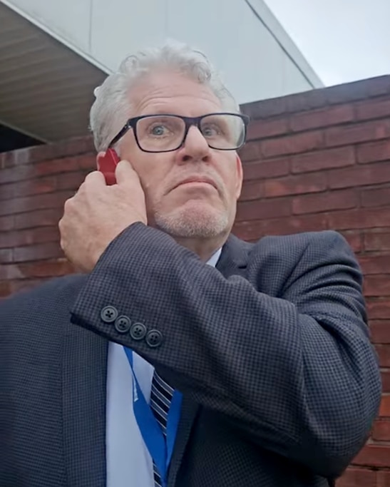 A screenshot from a video taken by parent Joe Hylton showing Somerset County Public Schools Board Chair Matthew Lankford on the phone with police outside of the Somerset County Board of Education in Westover.
