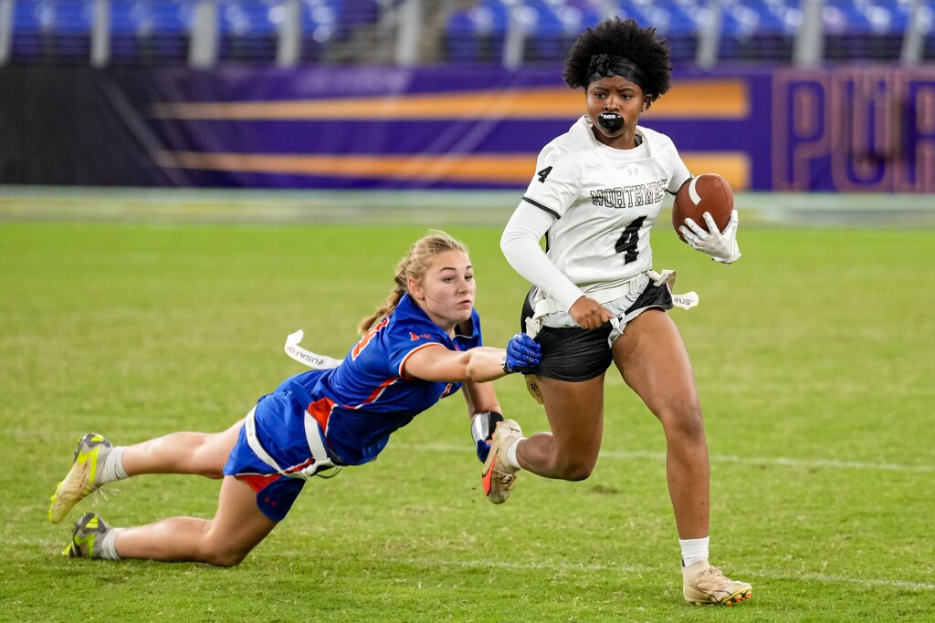 Boonsboro’s Sarah Mohler (14) dives after Northwest’s Chioma Ofulue (4) during the semi-finals of the 2024 Maryland High School Girls Flag Football Championship