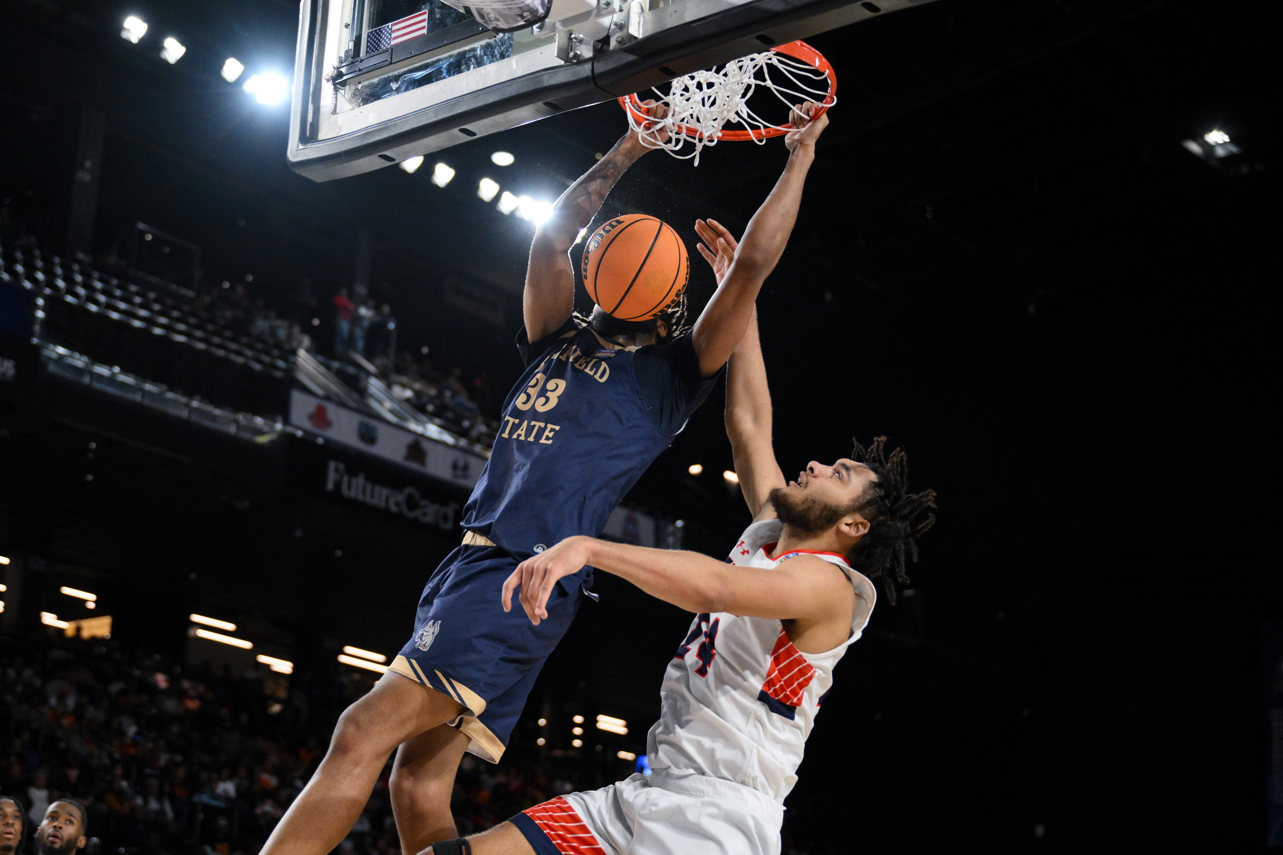 Bluefield State forward Shainen Carter (33) dunks the ball over Virginia State center Davian Coleman (24) during the CIAA tournament men’s final.