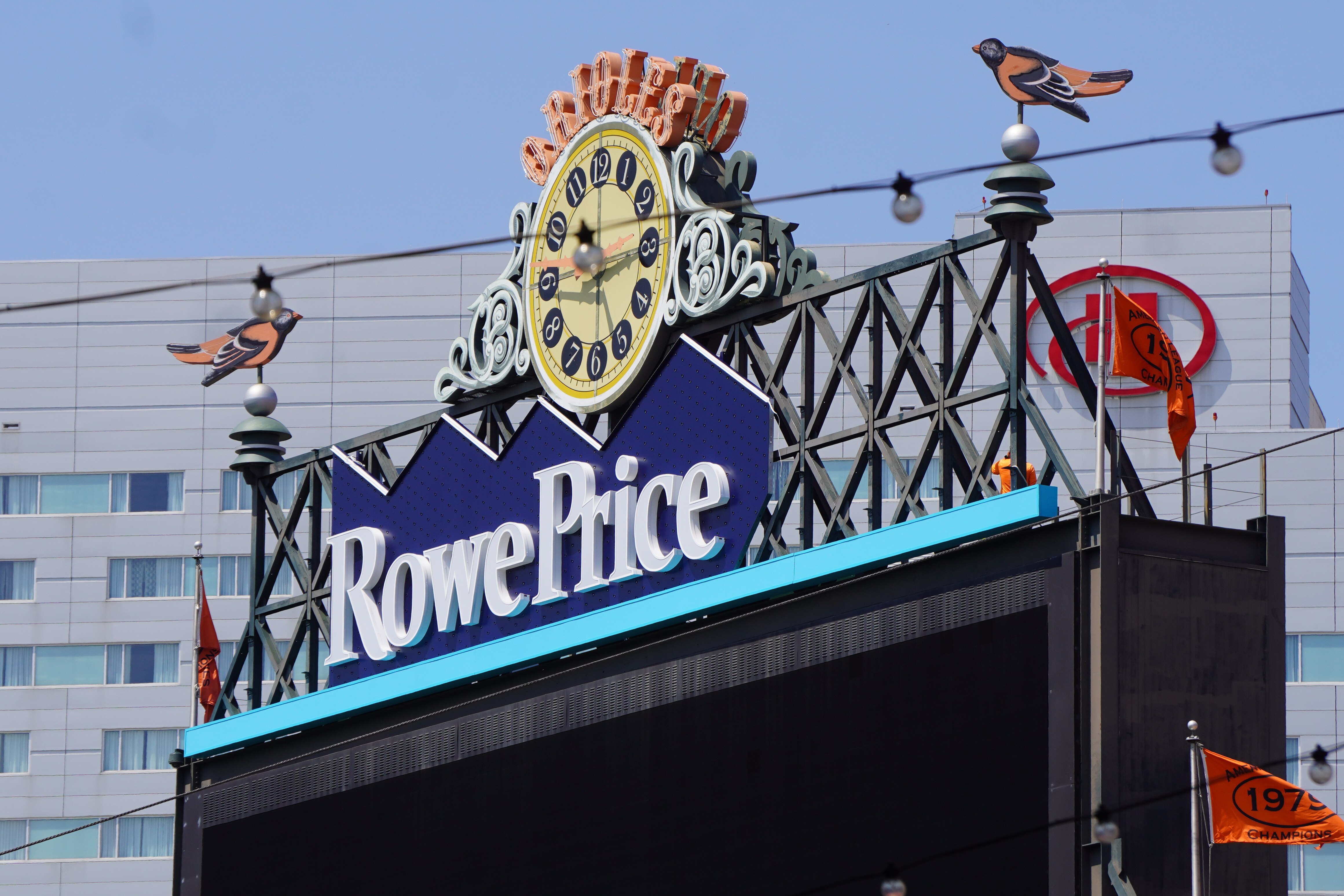 A view of the T. Rowe Price sign being installed atop the center field scoreboard at Oriole Park at Camden Yards.