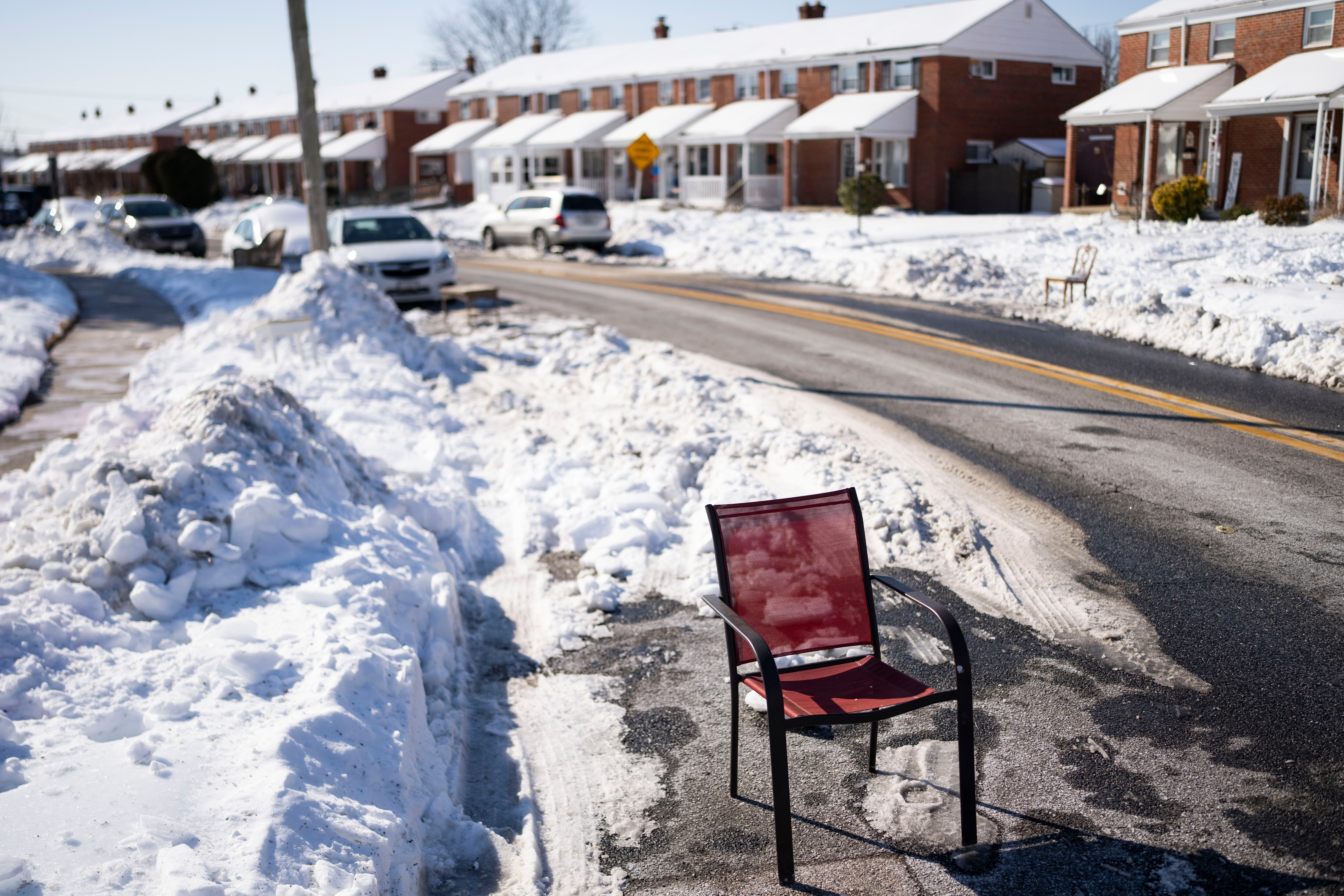 A lawn chair marks a shoveled-out parking spot in a Dundalk neighborhood on Wednesday. 
