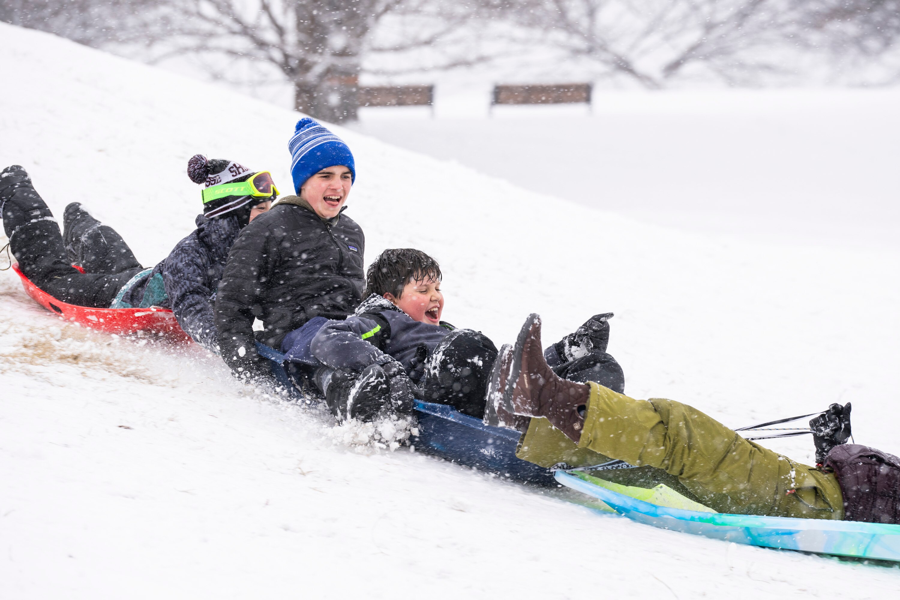The hill in front of the Observatory at Patterson Park was dotted with hundreds of kids who had a snow day. They brought sleds, floats, trash can lids, and more to take on the massive slope.