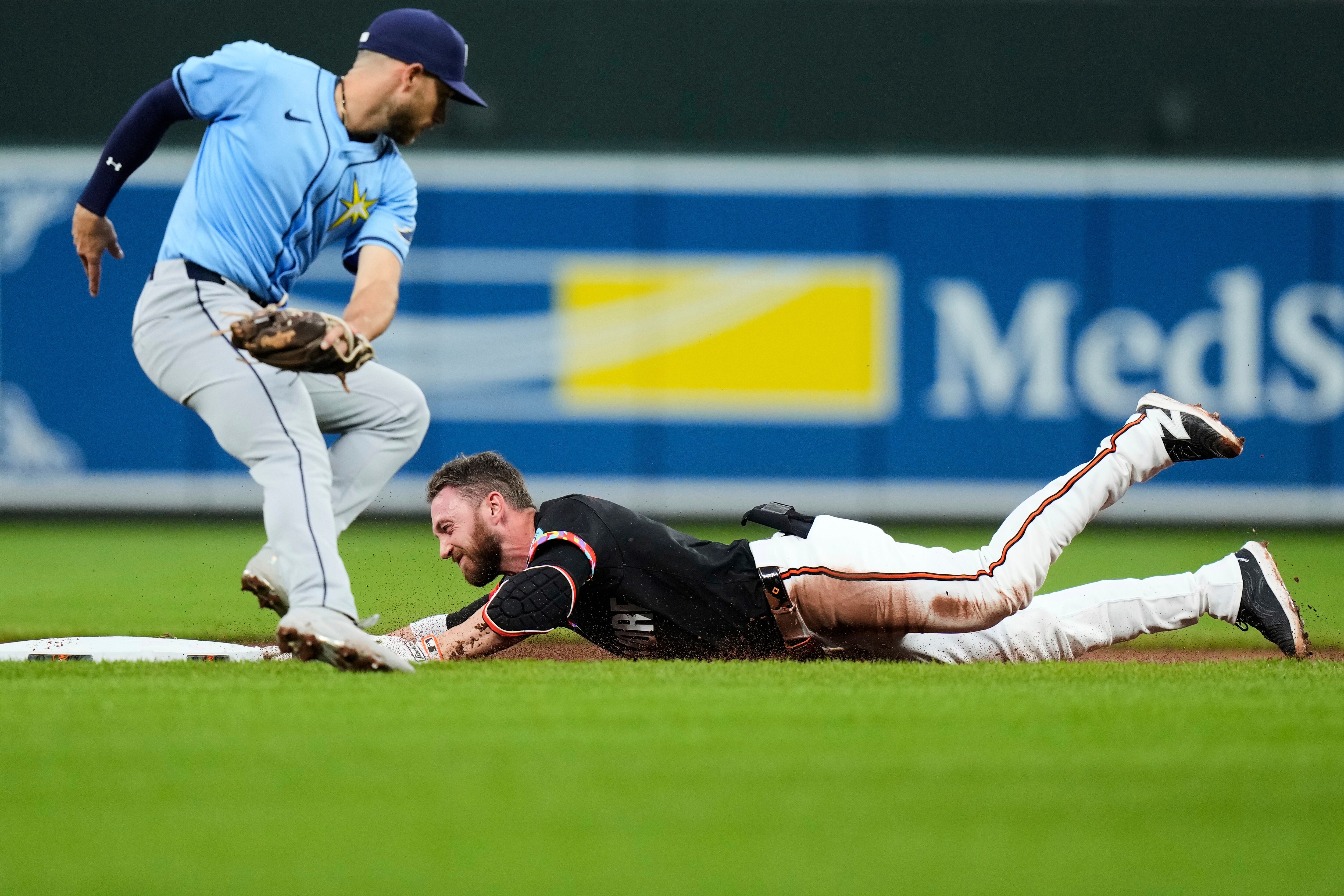 Jordan Westburg slides into second base, aggravating a hand injury, during the first inning Friday night at Camden Yards.