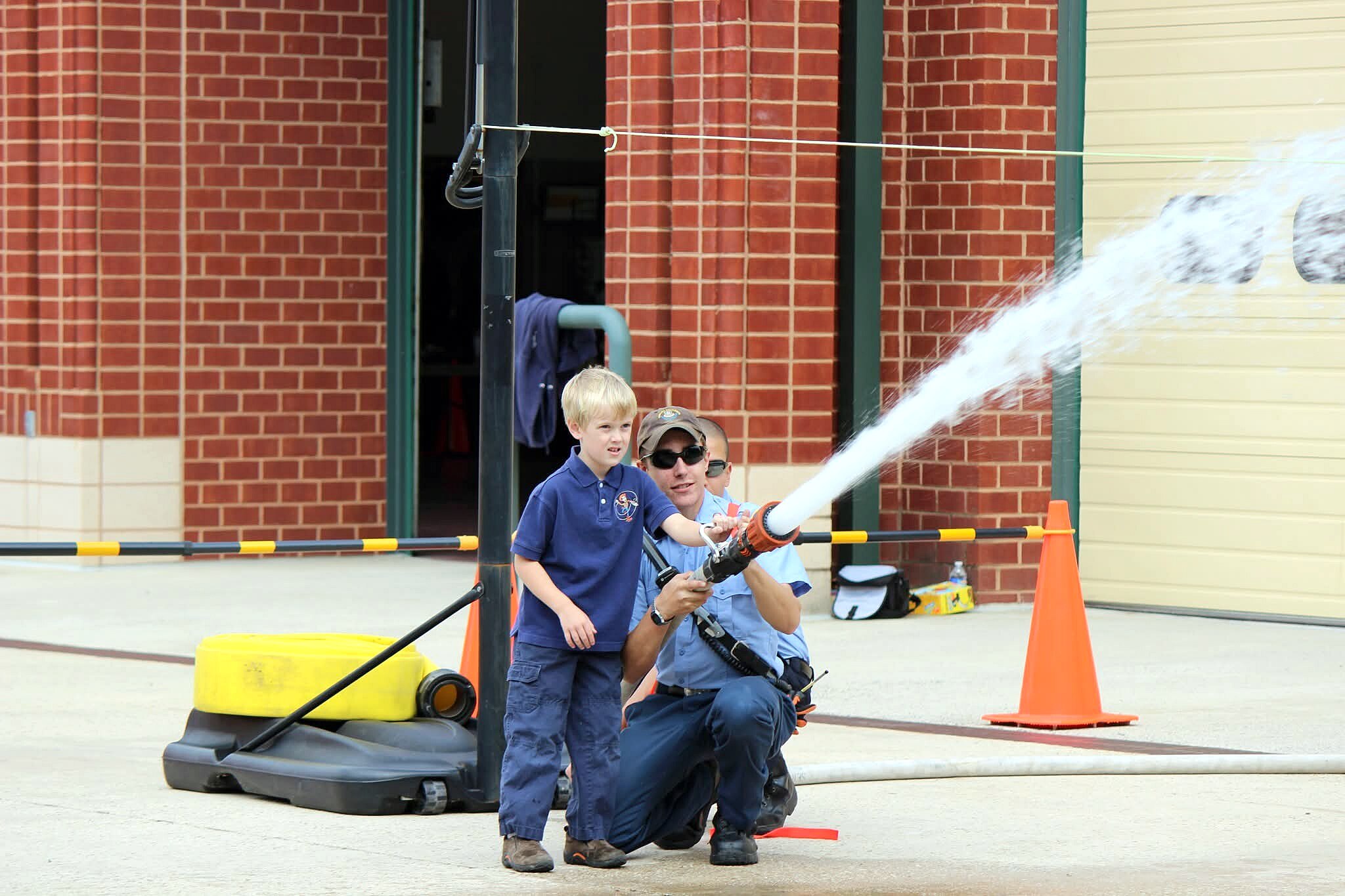 Kids will get a chance to use a real fire hose, like the one pictured here at a Clarksville Volunteer Fire Station open house, during the upcoming community day on Oct. 12.