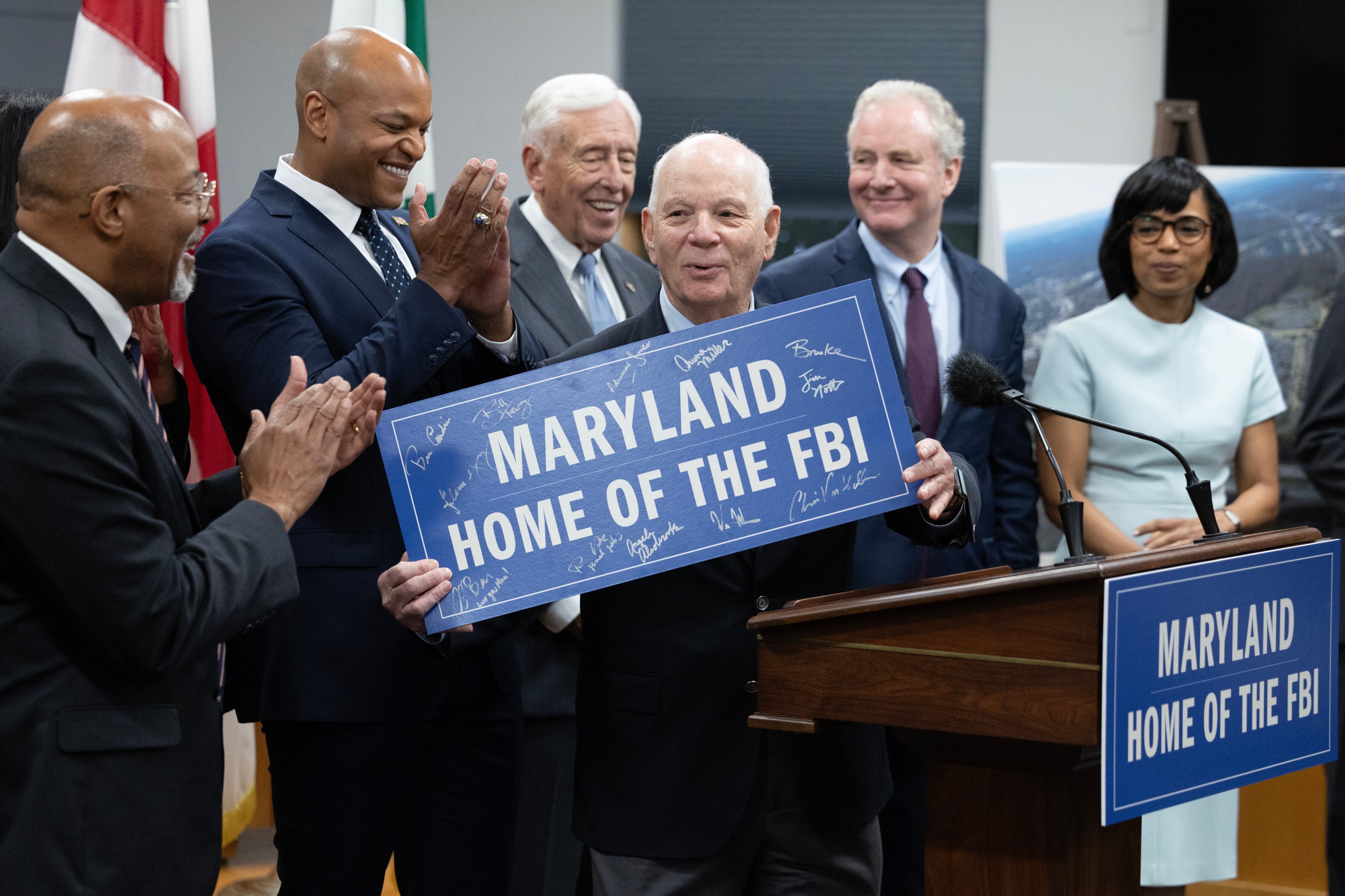 U.S. Senator Ben Cardin (D-MD) displays an autographed sign beside state and local officials, during a press conference on the Selection of Greenbelt for the FBI's New Headquarters in Greenbelt, Maryland, on Friday, November 10, 2023.